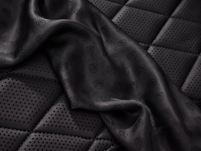 Quilted black leather interior of a LuxLimo chauffeur car