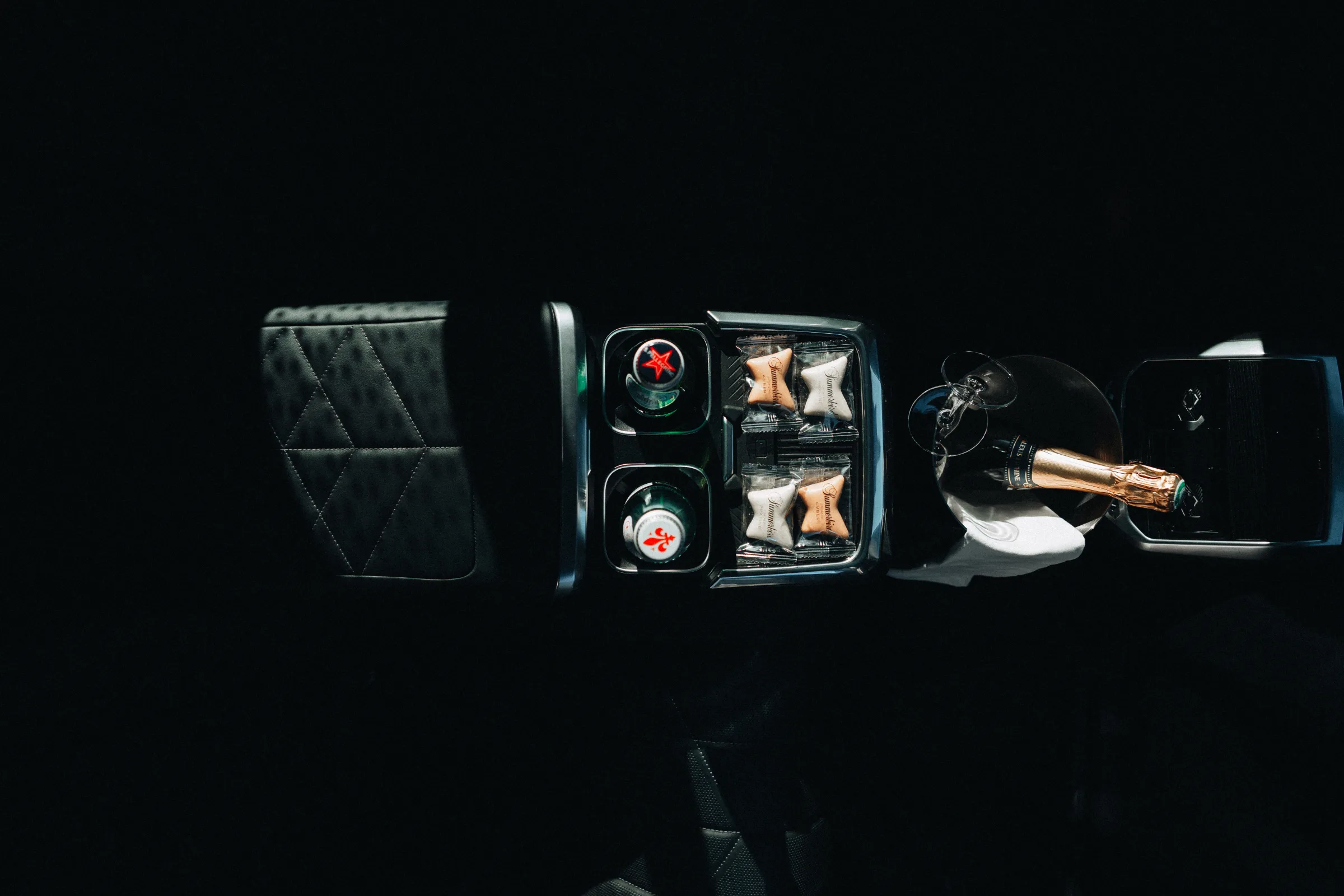 Rear console of a LuxLimo chauffeur car with still water, Summerbird chocolate and champagne